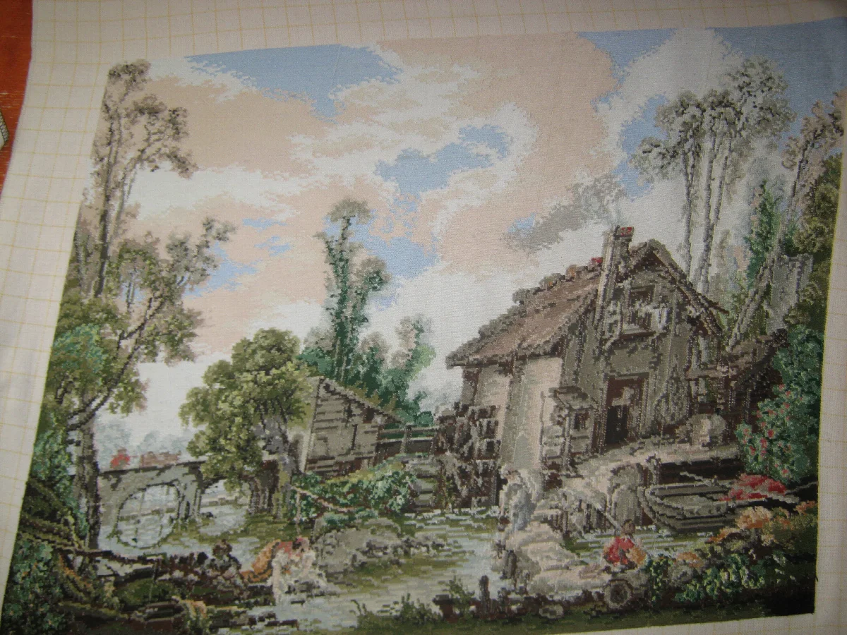 Reverse of the watermill needlework, showing the mirrored buildings, trees and stream